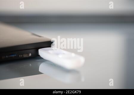 Closeup of white pendrive connected to USB port Stock Photo