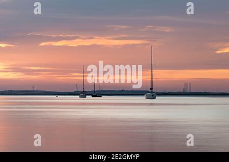 Boats on the Swale estuary in Kent at sunset. Taken from Harty Ferry, Faversham. Stock Photo