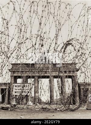 Vintage photo of Berlin Wall in 1961. Brandenburg Gate Seen Through Barbedwire Barrier Erected By The East Berlin Police. West Berlin. October 1961 Stock Photo