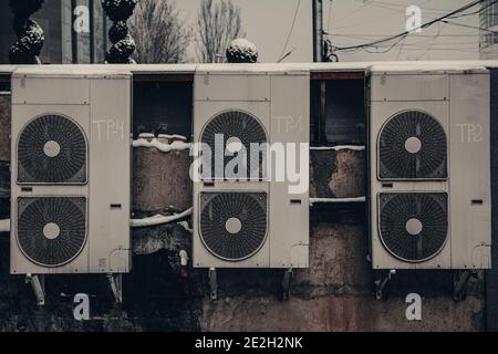 backside of the urban fashion store. dirty old air conditioners on a vintage  wall Stock Photo