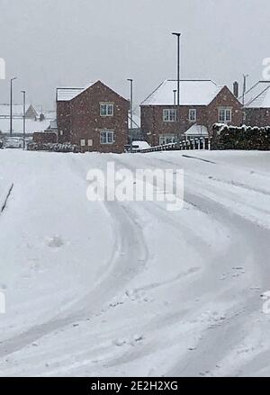 Snow covers a road in Monk Bretton, Barnsley, South Yorkshire, after the Met Office issued an amber snow warning for parts of Scotland and northern England overnight into Thursday, with up to 11cm falling in the Perth and Kinross area and 5cm in Cumbria by 9am, and large accumulations elsewhere. Stock Photo