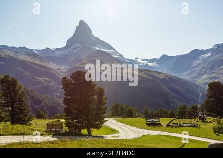 Sunny summer morning in Zermatt village with Matterhorn peak on backgroud. Beautiful outdoor scene in Swiss Alps, Switzerland, Europe. Stock Photo