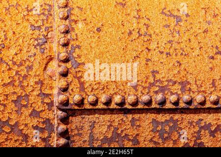 Rust texture grunge background of a rusty vintage cast iron textured panel frame with metal rivets, stock photo image Stock Photo