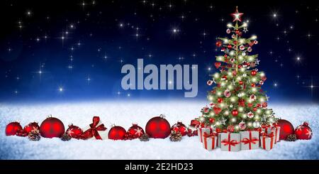 red silver christmas decoration ornament bauble gift boxes with ribbon and decorated xmas tree with bright lights in front of blue stars bokeh wide pa Stock Photo