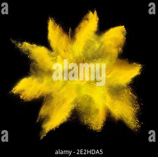 yellow orange holi paint color powder explosion isolated on dark black background. industry beautiful party festival concept Stock Photo