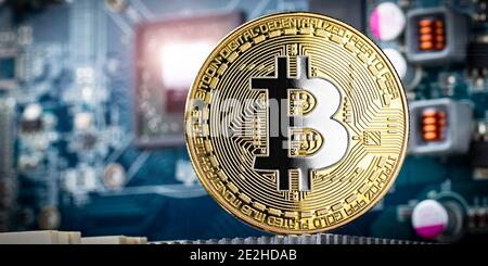 gold silver bitcoin crypto currency coin in front of high technology computer mining gpu hardware. Business digital financial concept Stock Photo