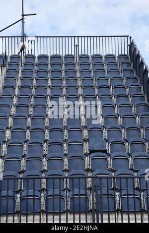 Rows of empty seats, with one seat folded down Stock Photo