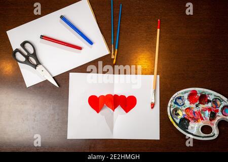Hand made greeting card for Valentines day. I love you sign painted with paint brush on white paper. Stock Photo