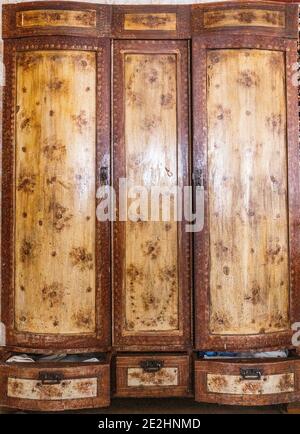 Old Soviet wooden wardrobe with three doors and drawers Stock Photo