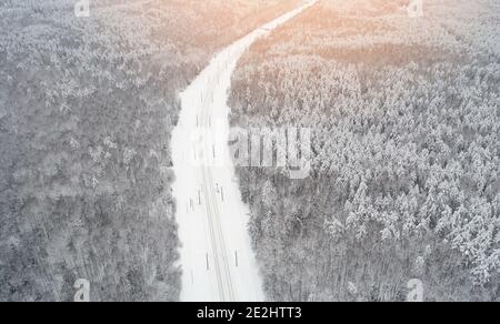 Railraod with electric cable in winter forest background aerial view Stock Photo