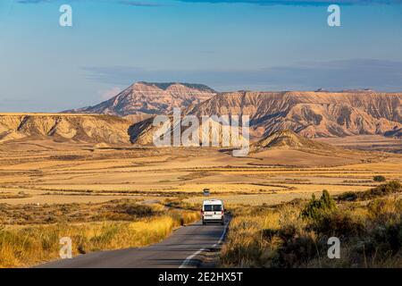 Spain: landscape, semi-desert natural region of the Bardenas Reales, Navarre. Roadtrip in the Bardenas: RV on a road Stock Photo