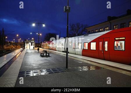 MOTALA, SWEDEN- 13 DECEMBER 2020: Commuter train by the platform in these corona times. Stock Photo