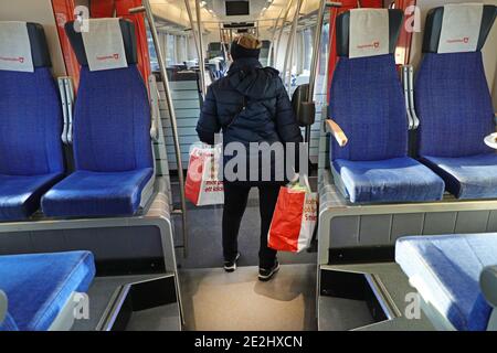 MOTALA, SWEDEN- 13 DECEMBER 2020: Woman with grocery bags on a commuter train in these corona times. Stock Photo