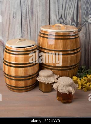 Sweet honey in barrel and jar with acacia flowers isolated on white Stock Photo