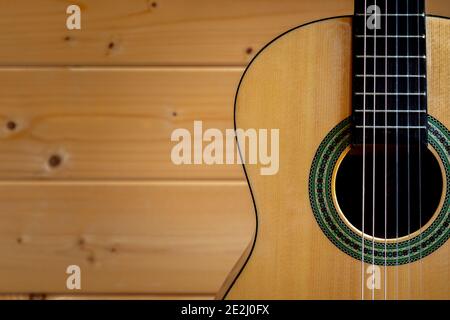 United Kingdom. 13th January 2021. A six string classical (or Spanish) guitar set against a pine wooden wall. Photographer : Brian Duffy Stock Photo