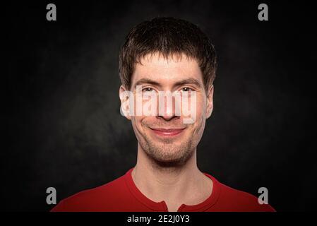 Portrait of a young man against a dark background Stock Photo