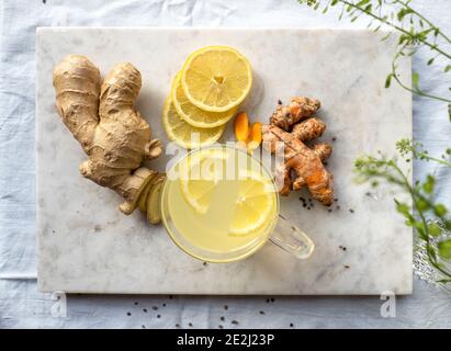 Top view of a glass of hot lemon and turmeric ginger tea, a healthy and naturally immune system boosting cold remedy Stock Photo