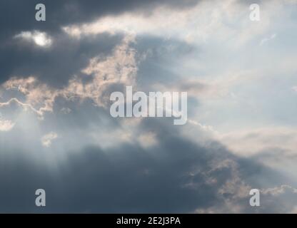 Concept: Hope, a cloudy sky with rays of sunlight breaking through Stock Photo