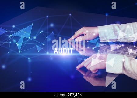 Businessman touching huge screen with AUDIT inscription, modern technology business concept Stock Photo