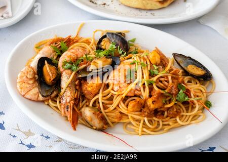 Pasta with grilled seafood. Traditional Greek dish. Stock Photo