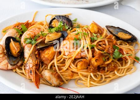 Pasta with grilled seafood. Traditional Greek dish. Stock Photo