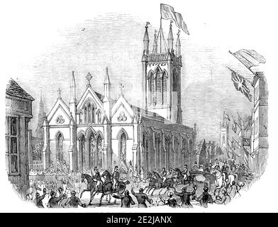 The procession, passing St. Michael's Church, Stamford, 1844. '...the procession passing the handsome church of St. Michael at Stamford, altered and modernised, by Mr. John Brown, architect, Norwich'. Queen Victoria and Prince Albert are welcomed by crowds during their stay with the Marquess of Exeter at nearby Burghley House in Lincolnshire.&#xa0;From &quot;Illustrated London News&quot;, 1844, Vol V. Stock Photo