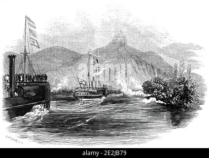 The Royal Yacht passing the Drachenfels, 1845. Queen Victoria and Prince Albert travel down the River Rhine during a royal visit to Germany. 'The group of hills called the Seven Mountains, in reality, are more than seven in number, and form a grand commencement to the beautiful scenery of the Rhine; they are the highest and wildest hills on its banks...'. The Drachenfels - Dragon's Rock - was formed by rising magma that could not break through to the surface, and then cooled and became solid underneath. On the summit is a ruined castle. From &quot;Illustrated London News&quot;, 1845, Vol VII. Stock Photo