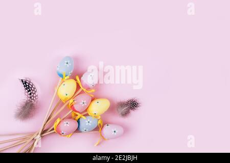 Colorful Easter eggs over pink background. Top view with copy space Stock Photo