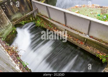 Water rushing under a weir on the River Avon in Salisbury, Wiltshire, UK. Stock Photo