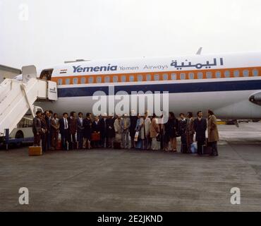 Businessmen and Women on Tarmac by Yemenia Airways Aeroplane Stock Photo