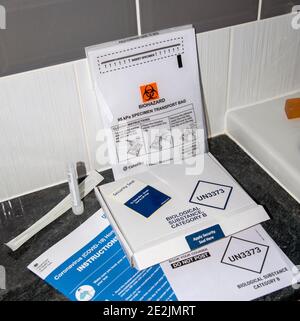 England, UK. 2021.  A Coronavirus, Covid-19 Home Test kit and contents including, swab, labels, box, plastic vial, biohazard bag and box for return Stock Photo