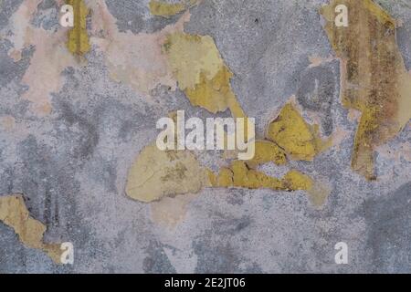 Grey weathered concrete wall with yellow paint texture, old rustic, free space for text or advertisement, toned Stock Photo