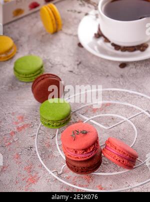 colorful macarons and cup of coffee over on gray background. Stock Photo