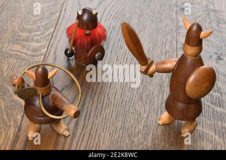 Three wood Viking figurines with sword trumpet and spear on wood planks Stock Photo