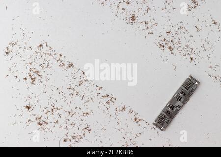 Cut off hair from shaving against white background with razor blade. Concept shaving or removing hair. Stock Photo