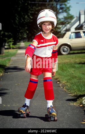 1980s LITTLE GIRL ROLLER SKATER WEARING RED OUTFIT PROTECTIVE GEAR SHOE SKATES KNEE & ELBOW PADS HELMET LOOKING AT CAMERA - 087333 TRA001 HARS SAFETY PLEASED JOY LIFESTYLE FEMALES SKATER HEALTHINESS HOME LIFE COPY SPACE FULL-LENGTH CONFIDENCE OUTFIT PROTECTIVE EYE CONTACT FREEDOM ACTIVITY HAPPINESS PHYSICAL CHEERFUL ADVENTURE LEISURE PROTECTION STRENGTH EXCITEMENT RECREATION PADS ELBOW SMILES FLEXIBILITY JOYFUL MUSCLES JUVENILES CAUCASIAN ETHNICITY OLD FASHIONED Stock Photo