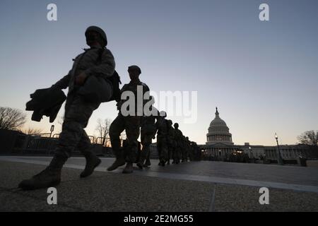 Washington, United States. 12th Jan, 2021. U.S. soldiers and airmen with the New Jersey National Guard arrive at the Capitol to establish security positions following the insurrection by Pro-Trump rioters January 12, 2021 in Washington, DCMore than 10,000 national guard troops have been deployed to provide security for the 59th Presidential Inauguration. Credit: Planetpix/Alamy Live News Stock Photo