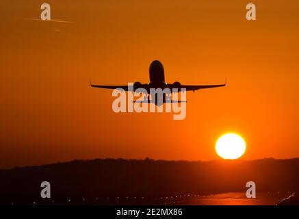 Krakow, Poland. 14th Oct, 2018. A plane seen taking off during sunset at Krakow's Balice airport. Credit: Alex Bona/SOPA Images/ZUMA Wire/Alamy Live News Stock Photo