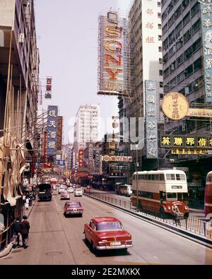 1970s CARS TRAFFIC DOUBLE DECKER BUSES ON NATHAN ROAD KOWLOON CITY DISTRICT OF HONG KONG - kr22261 MAY001 HARS VEHICLES BUSES KOWLOON NATHAN TRANSIT DECKER DISTRICT MOTOR VEHICLES OLD FASHIONED THOROUGHFARE Stock Photo