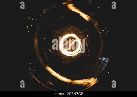 Lightbulb(s) and their glowing filaments shot in a dark interior of an upscale modern western-style saloon.  Orange and yellow glowing tones. Stock Photo