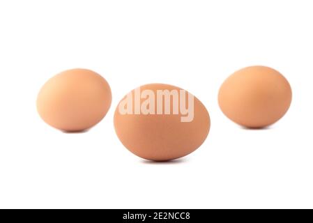 Soft focus. Three eggs over a white background. One egg in sharpness the rest are blurred. Stock Photo