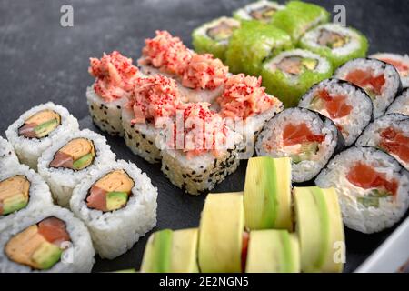 Sushi set of different rolls, with flying fish caviar, tobiko, shrimp, eel, salmon, avocado, sticks and soy sauce Stock Photo