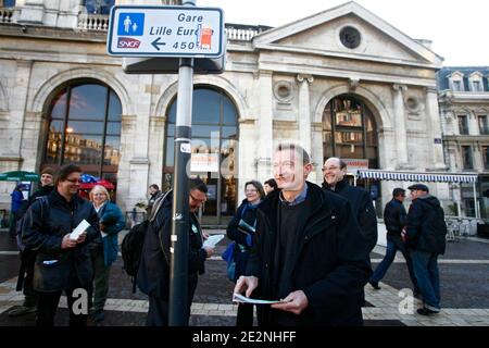 Loos-en-Gohelle mayor Jean-Francois Caron, head of list of 'Europe Ecologie' party for the Nord-Pas-de-Calais region for the March 7 regional elections, dispatches campaign pamphlets in the shape of a train ticket as he campaigns in Lille, north of France Stock Photo