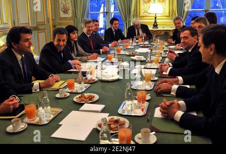 French President Nicolas Sarkozy (2dL) smiles before a meeting with his Russian counterpart Dmitry Medvedev (2dR), French State secretary for European Affairs Pierre Lellouche (L), and diplomatic advisor Jean-David Levitte (4thL) at the Elysee palace in Paris, France on March 1, 2010. Medvedev and a delegation of Russia's richest businessmen arrived in France today with two important deals in their pockets and high hopes of signing more. Medvedev' three-day visit begins with talks with Sarkozy, followed by a day of meetings with French business leaders and officials, including talks on controv Stock Photo