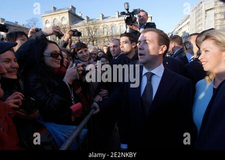 Russian President Dmitry Medvedev, 2nd right, his wife Svetlana, right, meet the crowd after visiting the Notre Dame cathedral, in Paris, France on March 2, 2010. Russia and France took their courtship to a new level in Paris on Monday, entering talks about the sale of four French warships to Moscow, standing together against nuclear-minded Iran and urging a new global financial order. Photo by Christophe Ena/Pool/ABACAPRESS.COM Stock Photo