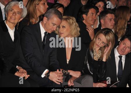 L-R) LVMH CEO Bernard Arnault, Charlize Theron and Delphine Arnault front  row for the Dior Fall-Winter 2010/2011 Ready-to-Wear fashion show held at  the Tuileries in Paris, France on March 5, 2010. Photo