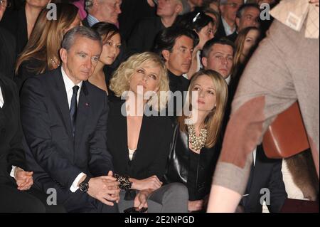 L-R) LVMH CEO Bernard Arnault, Charlize Theron and Delphine Arnault front  row for the Dior Fall-Winter 2010/2011 Ready-to-Wear fashion show held at  the Tuileries in Paris, France on March 5, 2010. Photo