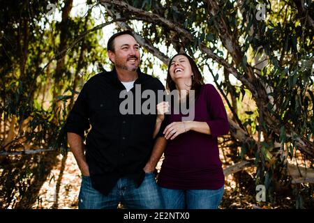 Husband & Wife Laughing Under Tree in Chula Vista Stock Photo