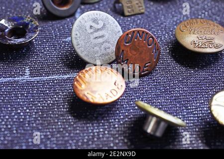 Buttons on denim fabric in workshop Stock Photo