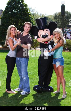 'Jake Pavelka (left), star of ABC's ''The Bachelor,'' strikes a dance pose March 13, 2010 with his fiancee, Vienna Girardi (second from left) while Mickey Mouse poses with professional dancer Chelsie Hightower (right), star of ABC's ''Dancing with the Stars,'' at the Magic Kingdom in Lake Buena Vista, Fla. Pavelka and Hightower are partners on the new season of ''Dancing with the Stars'' which premieres March 22, 2010. Pavelka, Girardi and Hightower were vacationing this weekend at Walt Disney World Resort. Photo By Matt Stroshane/Disney via ABACAPRESS.COM (Pictured: Jake Pavelka, Vienna Girar Stock Photo